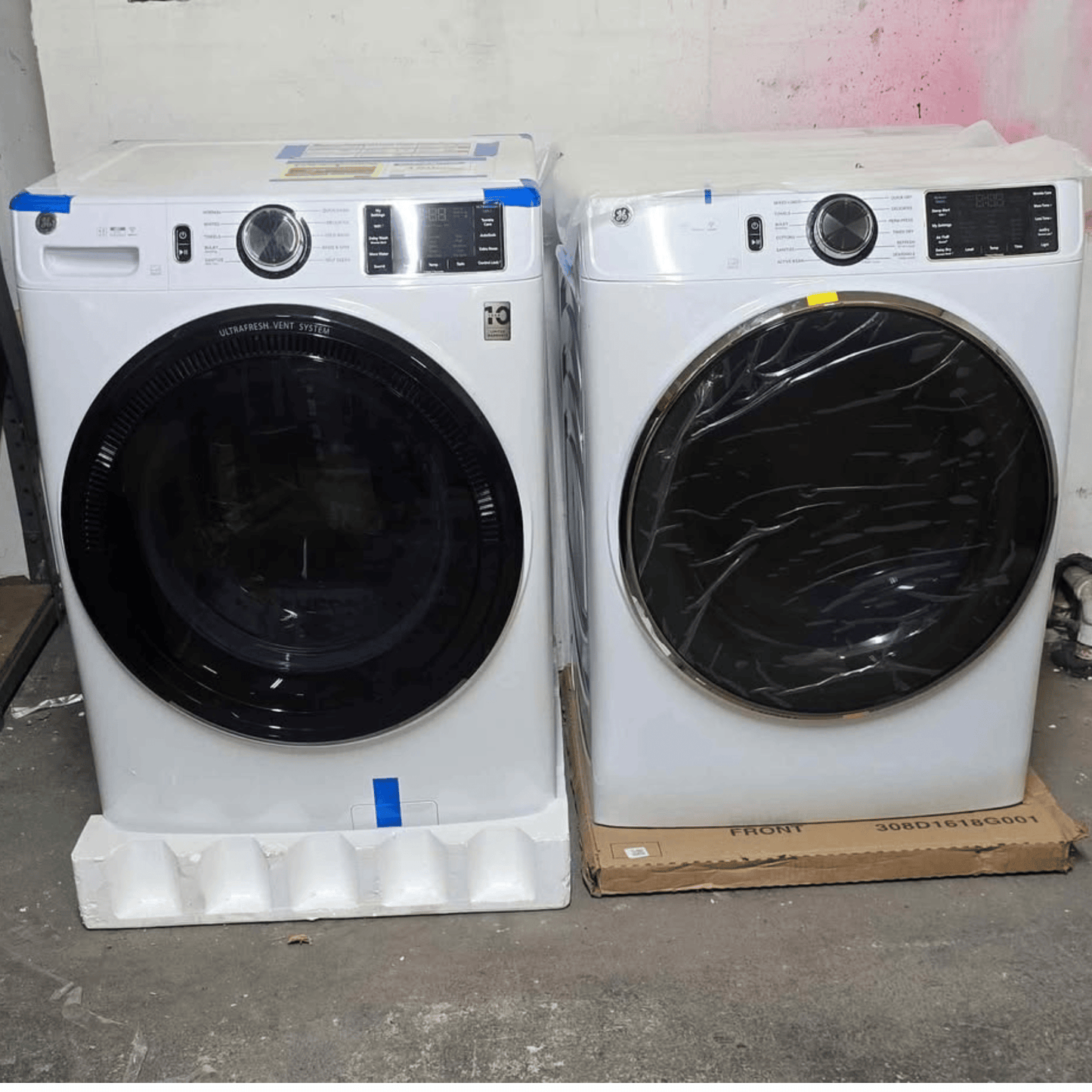 Brand new GE front load washer and dryer set, white, side by side view