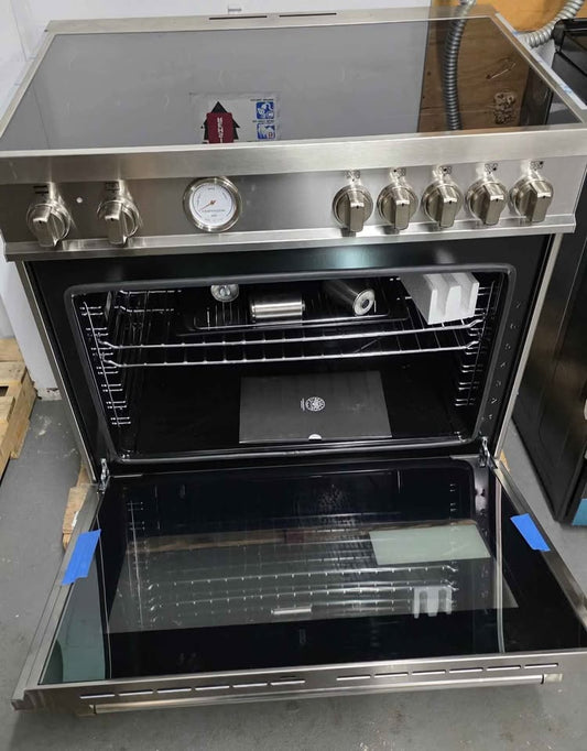 A stainless steel freestanding oven with its door open, showing the interior racks and glass door. The front has multiple control knobs, a round dial gauge, and a smooth cooktop surface.