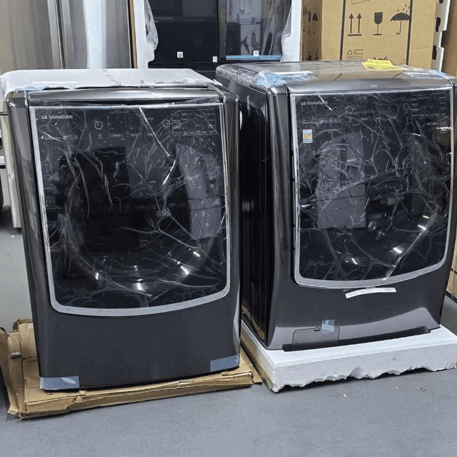 LG Signature front load washer dryer set doors open, factory packaging